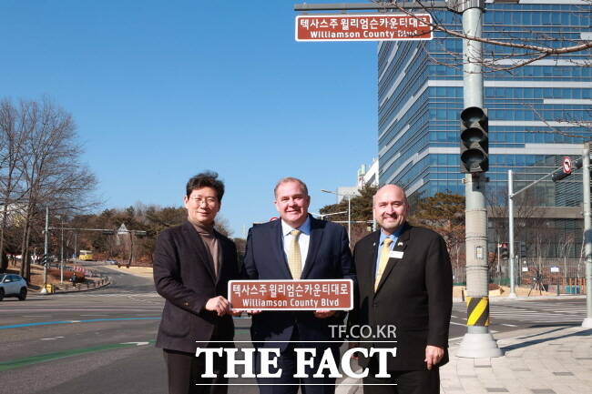 이상일(왼쪽) 용인시장이 지난 21일 용인을 방문한 러스 볼즈 윌리엄슨 카운티 커미셔너, 드웨인 아리올라 테일러시 시장과 함께 ‘윌리엄슨 카운티 대로’ 도로 표지판이 설치된 삼성전자 기흥 캠퍼스 앞을 찾아 현장을 살펴보고 기념사진을 찍고 있다./용인시