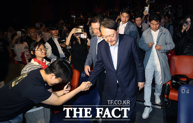 관람을 마치고 상영관을 나서며 지지자와 인사 나누는 윤석열 전 대통령.