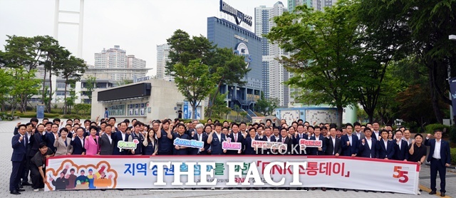 김태한 BNK경남은행장과 임직원 그리고 창원시 공무원들이 지역 상권 활성화를 위한 BNK소통데이 현수막을 들고 단체 기념촬영을 하고 있다./ BNK경남은행