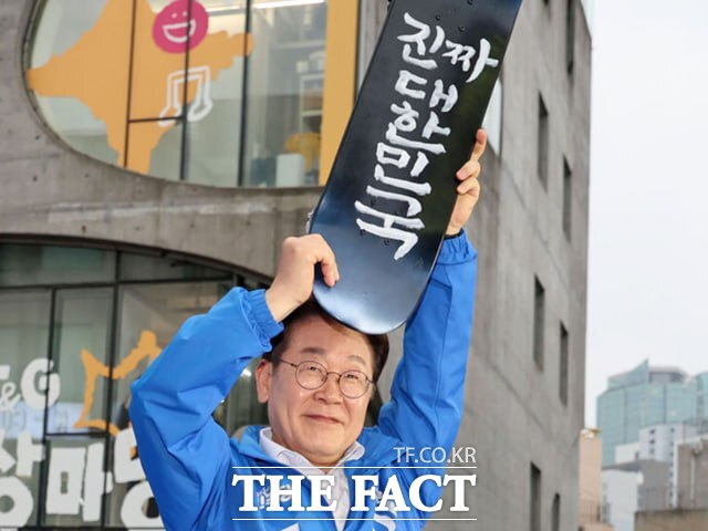 이재명 후보가 19일 서울 마포구 홍익대학교 앞 상상마당 유세장에서 선물받은 스케이트보드를 들어보이고 있다. /뉴시스