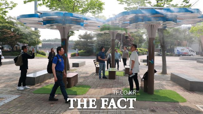 싱가포르 과학기술청이 과천 관문체육공원에서 인공지능 냉각기술 실증 쿨링포그 시스템을 시찰하고 있다. /과천시