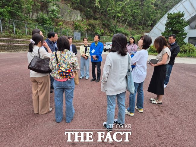 김성수 경기도의회 의원과 안양 근명중학교 학부모, 관계자들이 학교 운동장에서 이야기를 나누고 있다./경기도의회