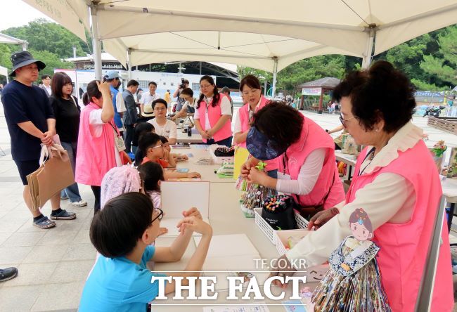 광명시민체육관 광장에서 열린 체험행사에서 아이들이 헌책 업사이클 활동을 하고 있다. /광명시