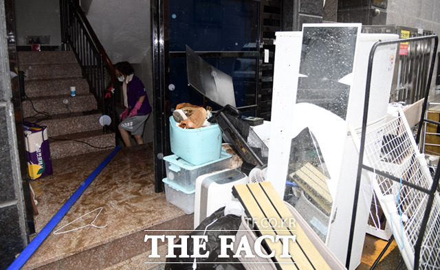 관악구에서 20년 넘게 살았다는 배모(92) 씨는 2년 전에 앞집에 물이 차 물을 막 퍼내던 게 기억난다며 지금은 그때보다 개선되긴 했지만 역시 걱정된다고 했다. 사진은 지난 2022년 8월9일 서울 관악구 신림동의 한 반지하 주택 주민이 집기를 밖으로 꺼내 침수된 물을 퍼내고 있는 모습. /이새롬 기자