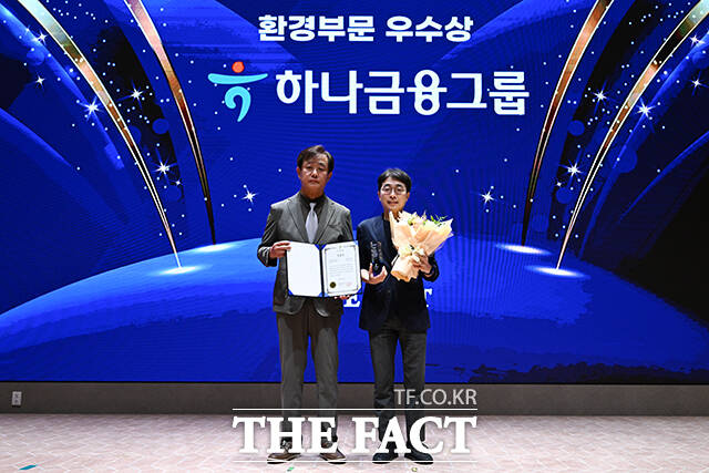 2025 ESG 경영대상 시상식이 26일 오후 서울 영등포구 여의도 한국거래소(KRX) 컨퍼런스홀에서 열린 가운데, 하나금융그룹이 환경부문 우수상을 수상했다. 정재웅 더팩트 편집국장(왼쪽)이 마지황 팀장에게 상패를 수여한 뒤 기념 촬영을 하고 있다. /장윤석 기자