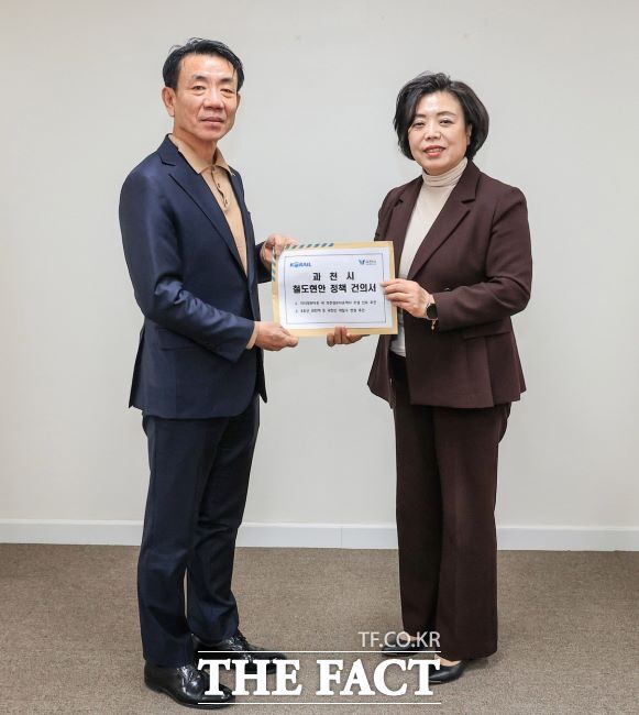 신계용 과천시장(오른쪽)이 지난 2월 한문희 한국철도공사 사장에게 지역 철도 현안 정책 건의서를 전달하고 있다. /과천시