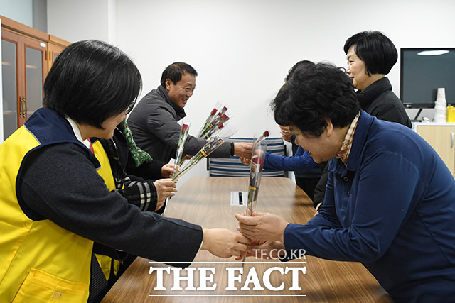 국회 청소 노동자의 임금에 대한 불만은 여전히 해결되지 않았다. 사진은 제116회 세계여성의날을 맞아 국회 소통관 노조 사무실을 찾은 노회찬재단 관계자들이 국회 여성 청소노동자들에게 장미를 선물하고 있는 모습. /남용희 기자