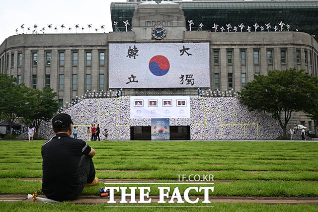 한 시민이 태극기 언덕을 바라보고 있다.