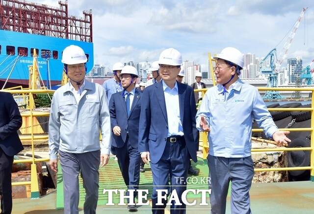 HD현대중공업 울산조선소를 방문한 조현 외교부 장관(가운데)이 HD현대 조석 부회장(오른쪽)과 이상균 사장(왼쪽)의 안내를 받으며 차세대 이지스 구축함 건조 현장을 둘러보고 있다. /HD현대