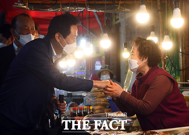 서울시는 자영업자를 위한 안심통장 2호를 오는 28일부터 출시한다고 18일 밝혔다. 오세훈 서울시장이 서울 서대문구 인왕시장을 찾아 상인들과 인사를 나누고 있다./더팩트 DB