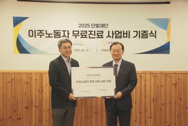 신희영 단빛재단 이사장(오른쪽)이 18일 서울 성북구 라파엘센터에서 열린 기부금 전달식에서 고재성 라파엘클리닉 대표이사와 기념 촬영을 하고 있다. /단빛재단