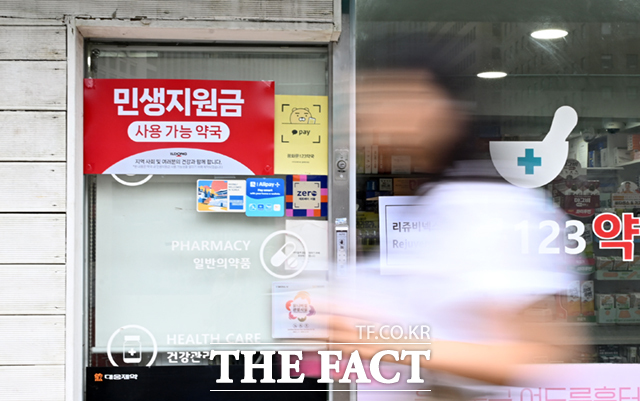 민생회복 소비쿠폰 1차 지급을 실시하는 지난 7월 21일 오전 서울 종로구의 한 약국에 민생회복소비쿠폰 사용처 안내문이 붙어 있다./이새롬 기자