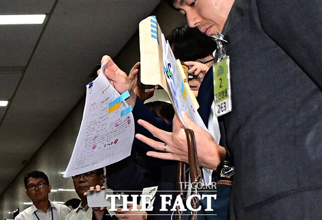 압수수색 영장 꺼내는 특검 수사관들.