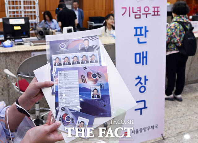 11일 오전 서울 중구 서울중앙우체국에서 이재명 제21대 대통령 취임 기념우표를 구입한 시민이 우표를 들어보이고 있다.