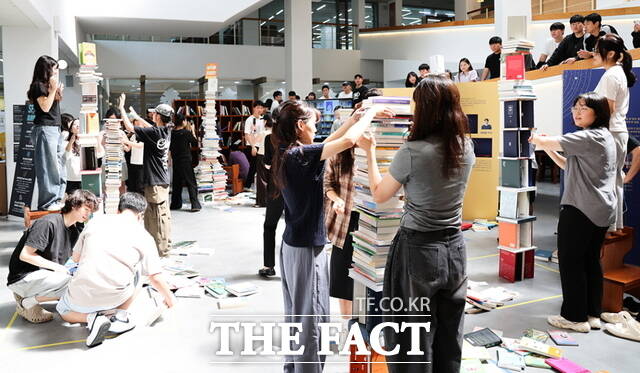 2025 SCH도서전 ‘SF, 미래의 서재‘ 개막식에서 학생들이 기증도서를 활용해 책 탑쌓기 이벤트에 참여하고 있다./순천향대학교