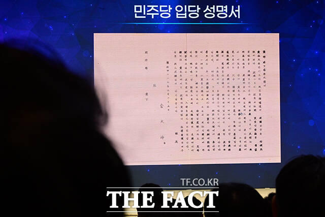 고 김대중 대통령의 민주당 입당 성명서 바라보는 민주당원.