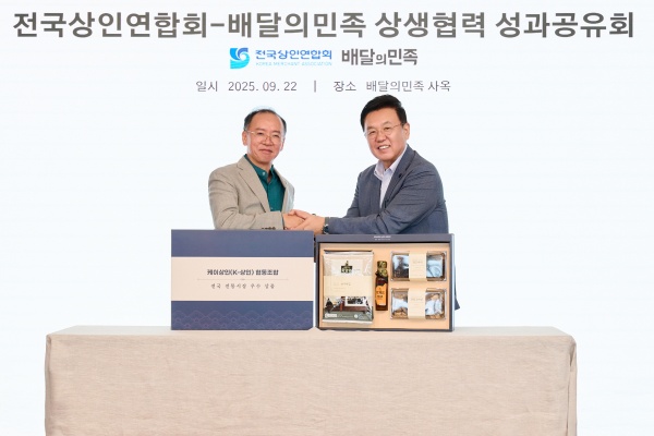 윤석준 우아한형제들 총괄사장(오른쪽)과 이충환 전국상인연합회 회장이 지난 22일 서울 송파구 롯데월드타워 사옥에서 ‘상생협력 성과공유회’를 기념해 사진 촬영을 하고 있다. /우아한형제들