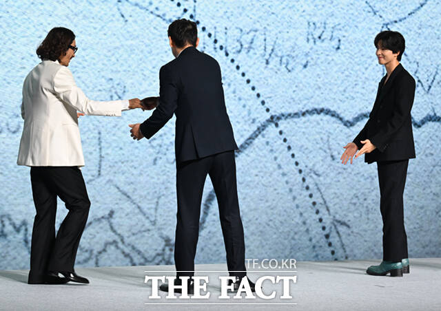 설경구 손에 이끌려 가운데로 향하는 류승범.