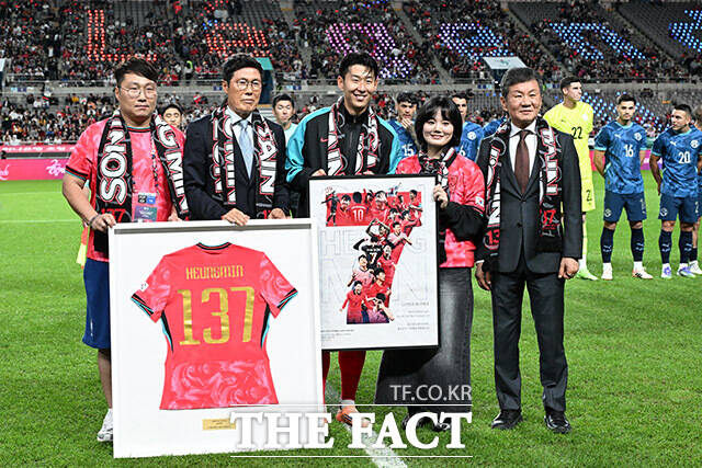 한국 남자 선수 A매치 최다 출전 달성에 성공한 손흥민(가운데)이 14일 오후 서울 마포구 서울월드컵경기장에서 열린 Legend Old & New – From Cha, To. Son 특별 행사에서 차범근 전 감독에게 기념 유니폼을 전달받은 뒤 기념촬영을 하고 있다./ 남용희 기자