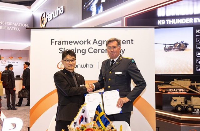 이부환 한화에어로스페이스 PGM사업부장(왼쪽)과 요나스 로츠네 스웨덴 방위사업청 지상무기체계국장이 14일(현지시간) 미국 워싱턴 DC에서 열린 AUSA 방산전시회에서 155㎜ 모듈형 추진장약 추가 공급 계약을 체결한 후 기념 촬영을 하고 있다. /한화에어로스페이스