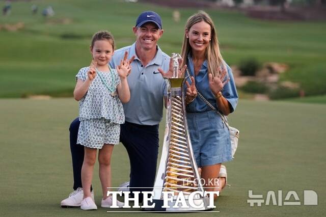 로리 맥길로이(가운데)가 레이스 투 두바이 시상식이 끝난 뒤 아내 에리카 스톨(오른쪽), 딸 포피와 함께 기념 사진을 찍고 있다. 두바이(UAE)/AP.뉴시스