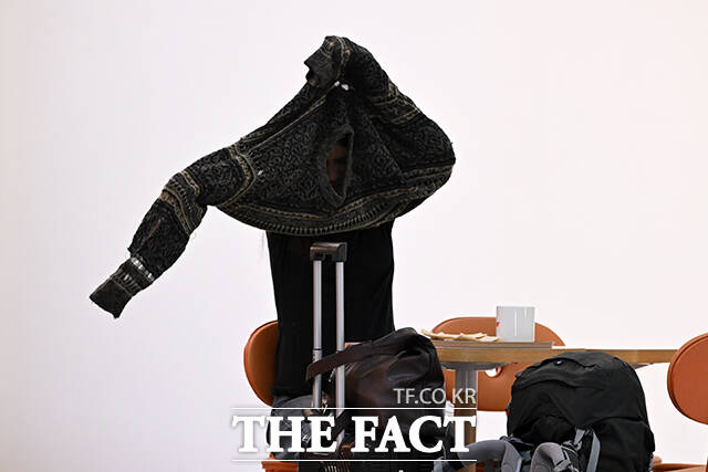 김포국제공항에서 한 시민이 겉옷을 입고 있다.