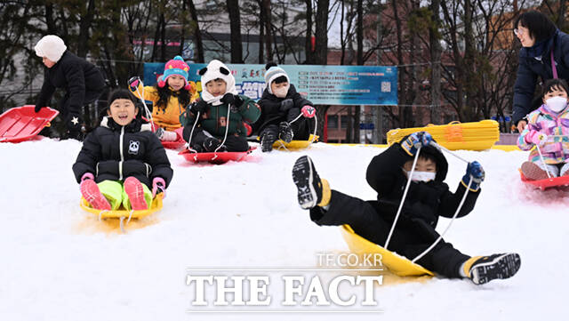 노원구가 23일 서울 노원구 서울과학기술대학교 종합운동장에서 '씽씽 눈썰매장'을 개장한 가운데, 오승록 구청장이 아이들과 눈썰매를 타고 있다.