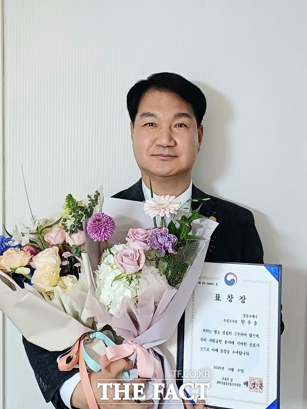 건양사이버대 동문인 한우송 집배원이 표창장을 들고 기념 촬영하고 있다. /건양사이버대