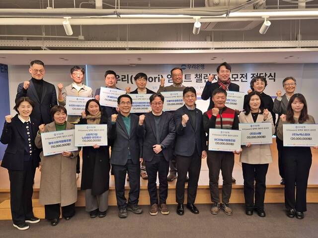 지난 27일 한국YWCA연합회 A-스페이스에서 열린 우리(Woori) 임팩트 챌린지 공모전 지원금 전달 식에서 (아래줄 왼쪽 4번째부터) 이의영 사회적경제활성화지원센터 이사장, 서종식 한국사회적기업진흥원 창업성장본부 본부장, 심성진 우리은행 ESG상생금융부 부장이 기념사진을 촬영을 했다. /우리은행