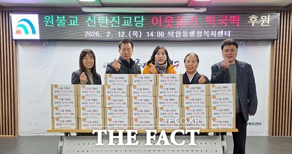 원불교 신탄진교당 관계자가 12일 대전시 대덕구 덕암동에 어려운 이웃을 위한 떡국떡을 기탁한 뒤 기념사진을 촬영하고 있다. /대덕구