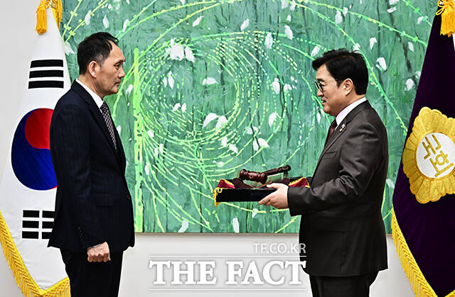 우원식 국회의장(오른쪽)이 25일 오전 서울 여의도 국회에서 열린 ‘국회기록원 제1호 기록물 기증식’에 참석해 본회의장에서 사용하던 의사봉과 의사봉판을 기증하고 있다. /국회=배정한 기자