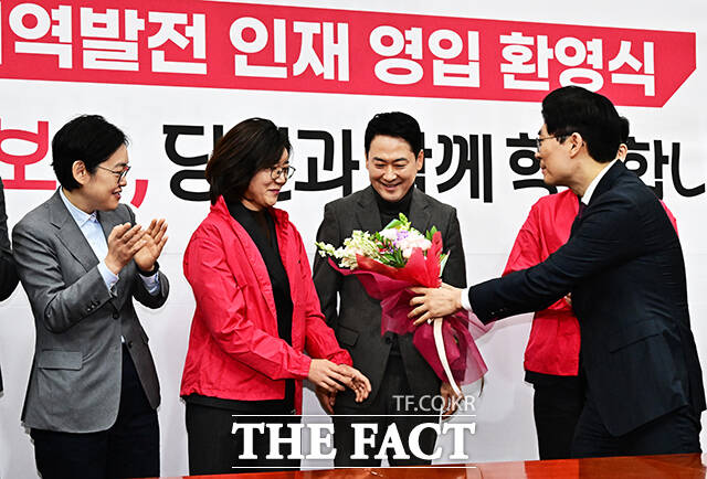 영인 인재들에게 꽃다발 선물하는 조정훈 국민의힘 인재영입위원장(오른쪽).