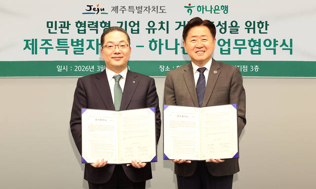 하나은행은 11일 하나은행 제주금융센터지점에서 제주특별자치도와 민·관 협력형 기업 유치 거점 조성을 위한 업무협약을 체결했다. 이날 협약식에 참석한 이호성 하나은행장(왼쪽)이 오영훈 제주도지사와 협약서를 들고 기념촬영을 하고 있다. /하나은행