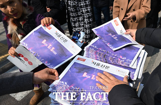 방탄소년단(BTS)의 서울 광화문광장 공연 하루 전인 20일 오후 서울 광화문 일대에서 시민들이 한 신문사가 발행한 BTS 관련 호외를 살펴보고 있다. /이새롬 기자