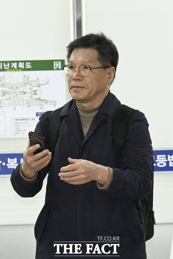 김병헌 대표가 법원 출입구 방향을 가리키고 있다.