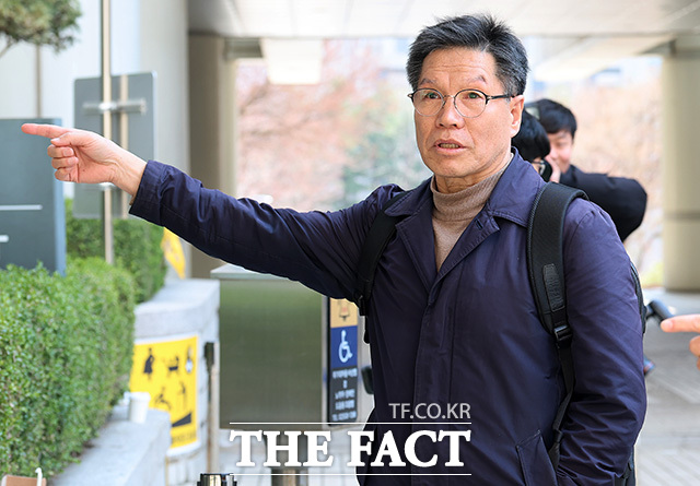 김병헌 대표가 법원 출입구 방향을 가리키고 있다.