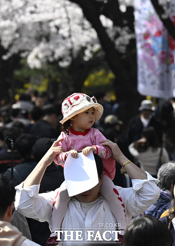 한 커플이 인형과 사진을 찍고 있다.
