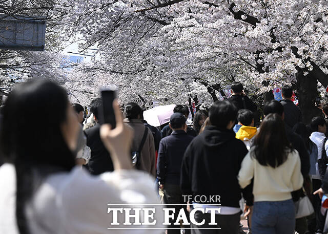 한 커플이 인형과 사진을 찍고 있다.