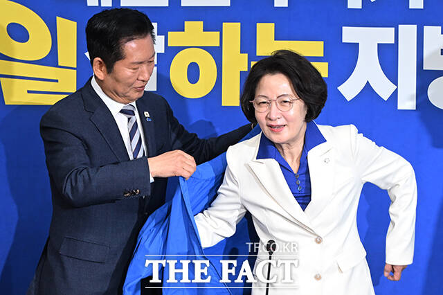 정청래 더불어민주당 대표(왼쪽)가 13일 오전 서울 여의도 국회에서 열린 최고위원회의에 앞서 추미애 경기도지사 후보에게 당 점퍼를 입혀주고 있다. /국회=김성렬 기자