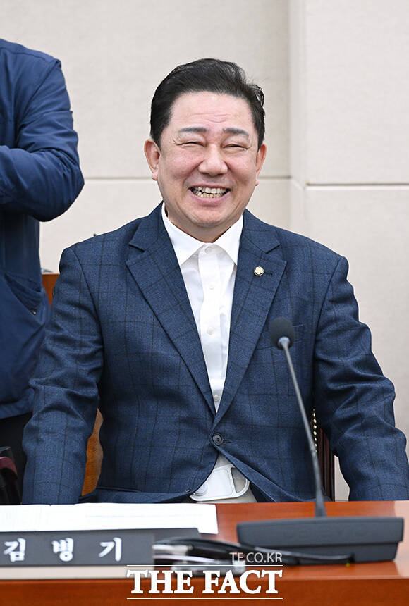 국방위 전체회의 참석해 황희 더불어민주당 의원과 인사 나누는 김병기 무소속 의원(오른쪽).