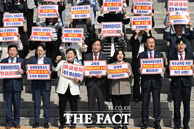 송언석 국민의힘 원내대표(앞줄 왼쪽에서 다섯 번째)와 정점식 정책위의장, 조지연 약자와의동행위원회 위원장 등이 15일 오전 서울 여의도 국회 본관 앞 계단에서 열린 '특수교육법 개정을 통한 선제적 장애 영유아 유보통합 시행 촉구대회'에 참석해 구호를 외치고 있다. /국회=김성렬 기자