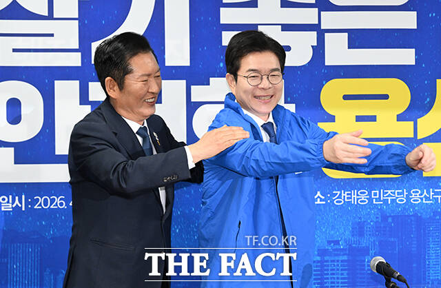 정청래 더불어민주당 대표(왼쪽)가 17일 오전 서울 용산구에 마련된 강태웅 용산구청장 후보 선거사무소에서 열린 현장 최고위원회의에서 정원오 서울시장 후보에게 당 점퍼를 입혀주고 있다. /박헌우 기자