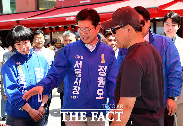 정원오 더불어민주당 서울시장 후보(가운데)가 25일 오후 서울 중구 남대문시장을 찾아 시민들과 인사를 하고 있다. /박상민 기자
