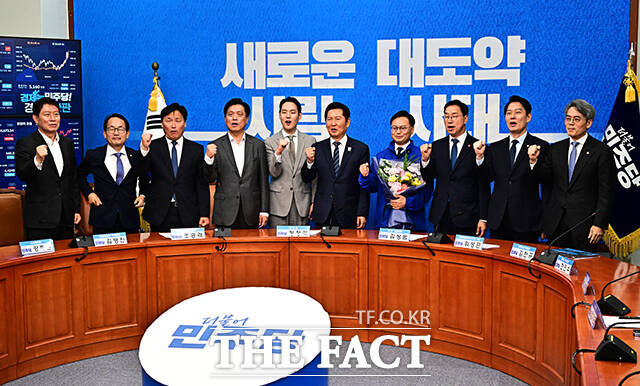 정청래 더불어민주당 대표(왼쪽)가 30일 오전 서울 여의도 국회에서 열린 3차 인재영입식에 참석해 6.3 재보궐선거 제주 서귀포시 후보로 영입한 김성범 전 해수부 차관에게 파란색 점퍼를 입혀주고 있다. /국회=배정한 기자