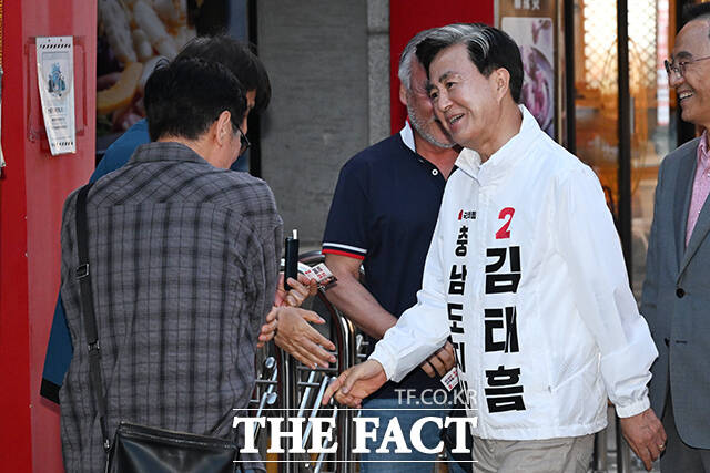 김태흠 국민의힘 충남도지사 후보(오른쪽)가 22일 오후 충남 천안 동남구 신부문화거리에서 시민들에게 인사하고 있다. /천안=김성렬 기자