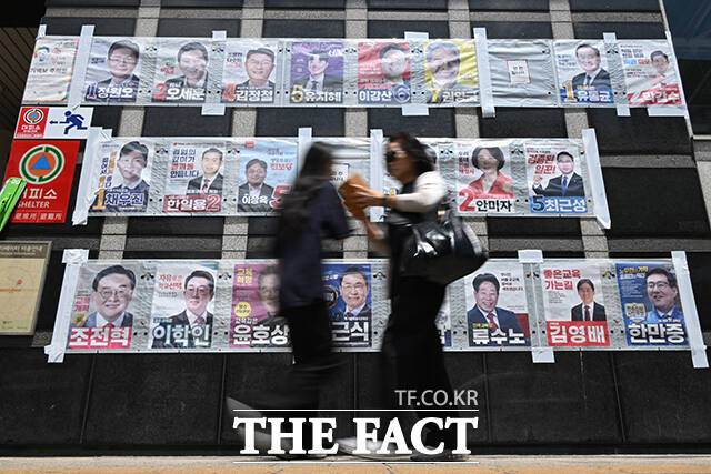 6·3 지방선거와 국회의원 재·보궐선거 사전투표를 하루 앞둔 28일 서울 마포구 망원역 앞에서 한 시민이 서울특별시장, 서울시교육감, 마포구청장 등 후보자들의 선거 벽보를 바라보고 있다. /남윤호 기자