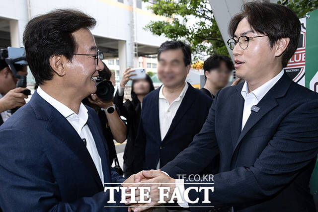 투표소 앞에서 만나 인사하는 전 후보(왼쪽)와 하 후보.
