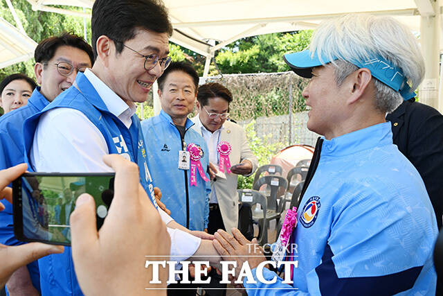 서울특별시 족구협회장기 족구대회에 참석해 관계자들과 인사 나누는 정원오 후보(왼쪽).