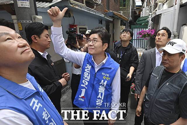 쪽방촌을 살펴보던 정 후보가 주민들을 향해 인사하고 있다.