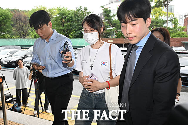 올림픽공원 핸드볼경기장 개표소 봉쇄 시위 중 체육단체의 경기장 진입을 막은 30대 여성 A 씨(가운데)가 10일 오후 서울 송파구 송파경찰서에 업무방해 혐의로 출석하고 있다. /박헌우 기자